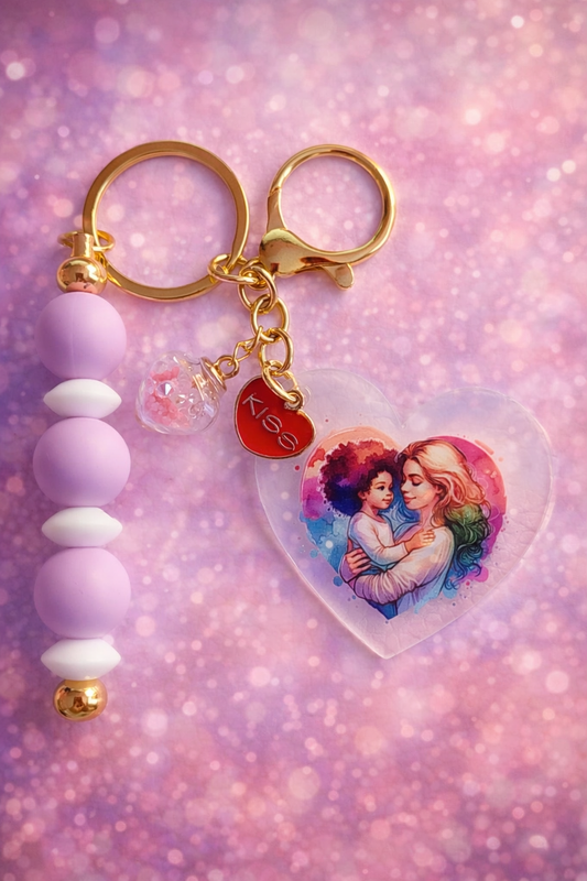 Porte clés avec un petit cœur rouge et un cœur avec des petite perle de couleur la couleur or des anneaux