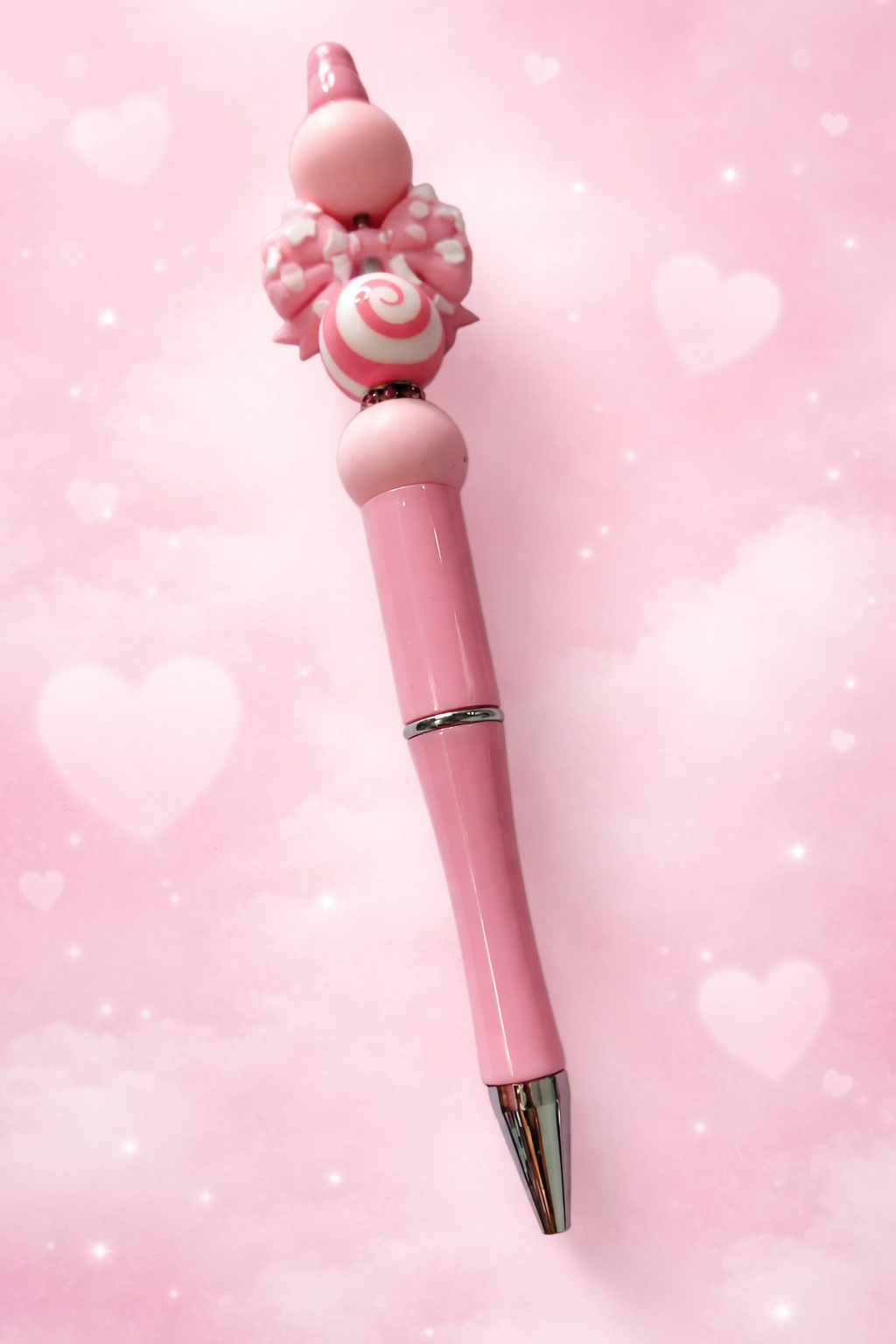 Stylo perle en silicone rose avec un nœud 