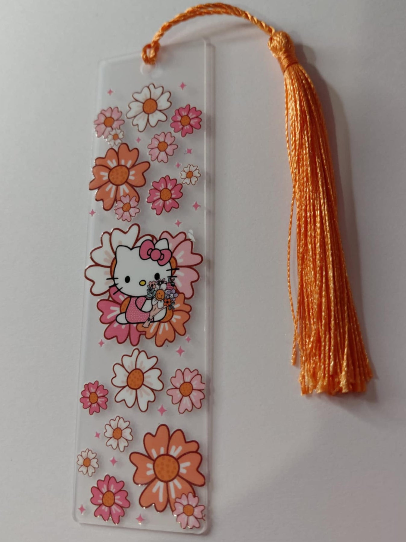 Marque pages avec une image des fleurs et kitty pompon orange 